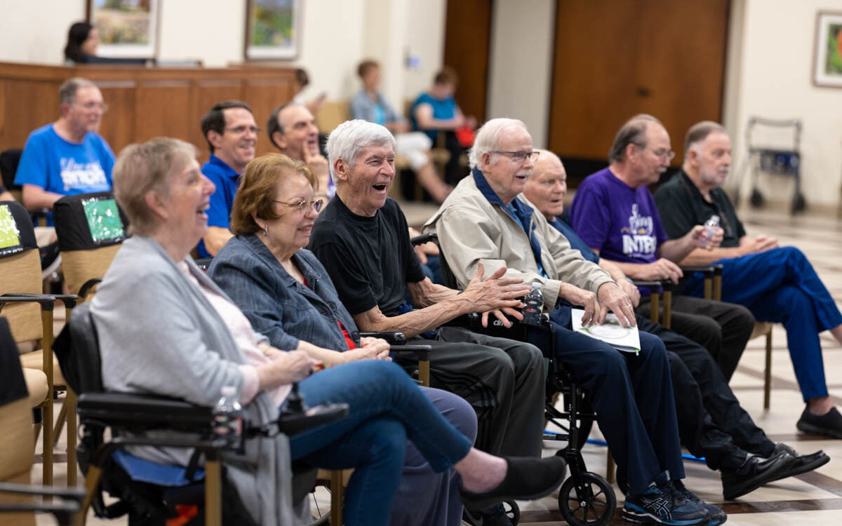 People with Parkinson's disease in a crowd laughing